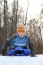 Boy intend drive from hill in winter on sledges Royalty Free Stock Photo