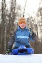 Boy intend drive from hill in winter on sledges Royalty Free Stock Photo