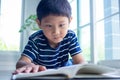 The boy intends to read books or do homework. Children study at home during school holidays.