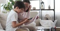 Boy interrupting mother working from home