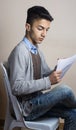 Boy itting on chair inside studio Royalty Free Stock Photo