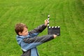 Boy in jacket with cinema clapper board Royalty Free Stock Photo