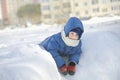 Boy In Jacket Leaning On Snow Heap