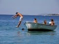 Boy jump from the boat into the sea Royalty Free Stock Photo