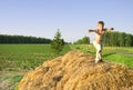 Boy jump on a hayrick and throw a straw Royalty Free Stock Photo