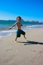 Boy jumping around on the beach