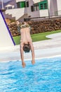 Boy jumping in the blue pool Royalty Free Stock Photo