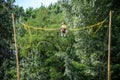 The boy is jumping on a bungee trampoline. A child with insurance and stretchable rubber bands hangs against the sky. The concept