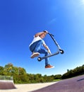 Boy jumping with his scooter Royalty Free Stock Photo