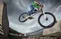 Boy jumping with his street-bike in the city.