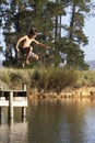 Boy Jumping From Jetty Into Lake Royalty Free Stock Photo