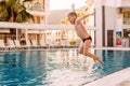 boy jumping in an outdoor pool Royalty Free Stock Photo