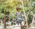 Boy jumping over the rope in the park on sunny summer day. Royalty Free Stock Photo