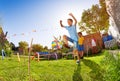 Boy jumping over string in competition game