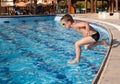 Boy jumping into the pool Royalty Free Stock Photo