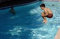 Boy jumping in the pool Royalty Free Stock Photo