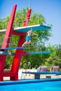 Boy jumping into a pool Royalty Free Stock Photo