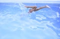 Boy jumping into the pool water Royalty Free Stock Photo