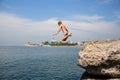 Boy jumping into the sea from the old pier, Vladivostok