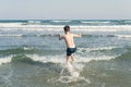 Boy Jumping In Sea Waves with Water Splashes. Concept Royalty Free Stock Photo