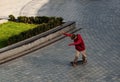 Boy jumping on skateboard at the street. Funny kid skater practicing ollie on skateboard at sunset. Royalty Free Stock Photo