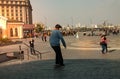 Boy jumping on skateboard at the street. Funny kid skater practicing ollie on skateboard at sunset. Royalty Free Stock Photo