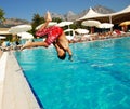 Boy jumping into swimming pool Royalty Free Stock Photo