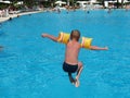 Boy jumping in swimming pool Royalty Free Stock Photo