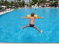Boy jumping in swimming pool Royalty Free Stock Photo