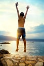 Boy jumping and taking a deep breath at the sunset Royalty Free Stock Photo