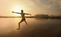 Boy jumping to water with sunset Royalty Free Stock Photo