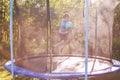 Boy jumping on trampoline. child playing with a ball Royalty Free Stock Photo