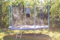 Boy jumping on trampoline. child playing with a ball Royalty Free Stock Photo