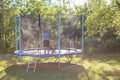 Boy jumping on trampoline. child playing with a ball Royalty Free Stock Photo