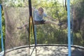 Boy jumping on trampoline. the child plays on a trampoline Royalty Free Stock Photo