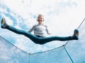 Boy jumping on trampoline, open legs Royalty Free Stock Photo