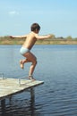 Boy jumping into water Royalty Free Stock Photo