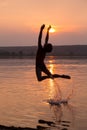 Boy jumping into water on sunset Royalty Free Stock Photo