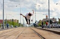 Boy jumps backflip on tramlines in the city Royalty Free Stock Photo