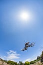 Boy jumps with his dirt bike over the ramp at an artificial trial