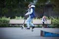 Boy jumps with his scooter at the skate park. The concept of a healthy lifestyle. Kids sport. Royalty Free Stock Photo