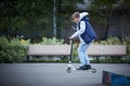 Boy jumps with his scooter at the skate park. The concept of a healthy lifestyle. Kids sport. Royalty Free Stock Photo