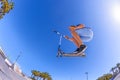 Boy jumps with his scooter at a skate park Royalty Free Stock Photo