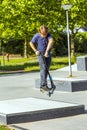 Boy jumps with his scooter at a skate park Royalty Free Stock Photo