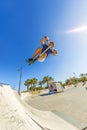 Boy jumps with his scooter at a skate park Royalty Free Stock Photo