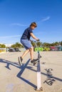 Boy jumps with his scooter at a skate park Royalty Free Stock Photo