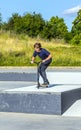 Boy jumps with his scooter at a skate park Royalty Free Stock Photo