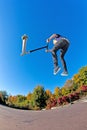 Boy jumps with his trick scooter Royalty Free Stock Photo