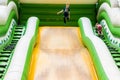 The boy jumps from an inflatable slide