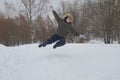 Boy jumps over the snow